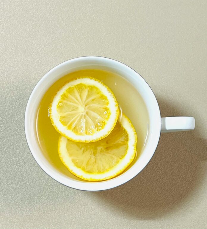A cup of tea with lemon slices in it