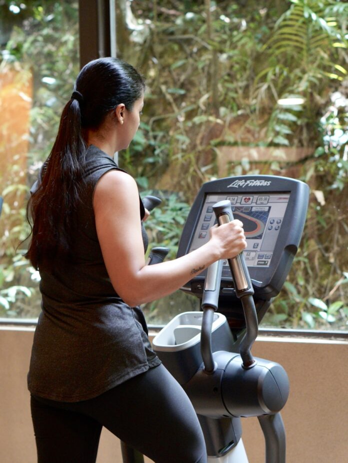 Photo by Aparna Johri a woman using a weight machine