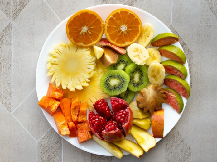 Photo by VD Photography a white plate topped with cut up fruit