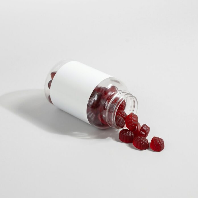 Photo by Supliful - Supplements On Demand a white and red capsule